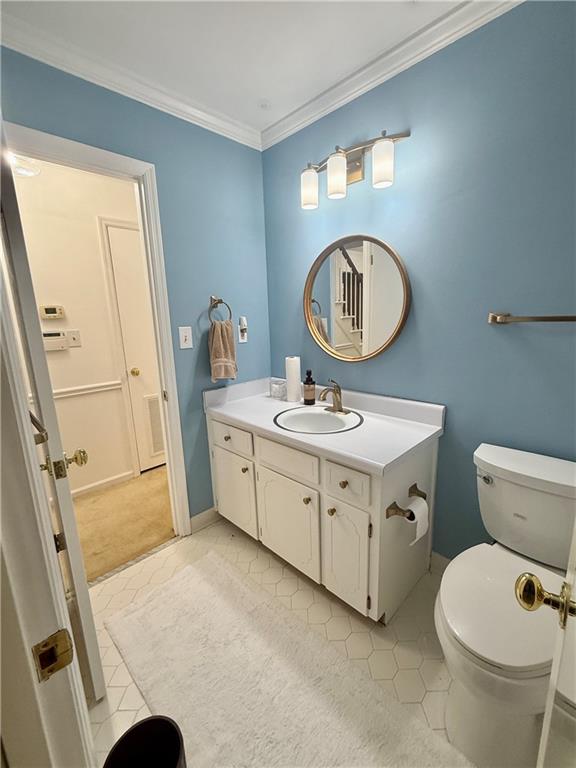 5705 Orly Terrace Atlanta, GA 30349 - Photo 8 of 42 a bathroom with a toilet sink and mirror