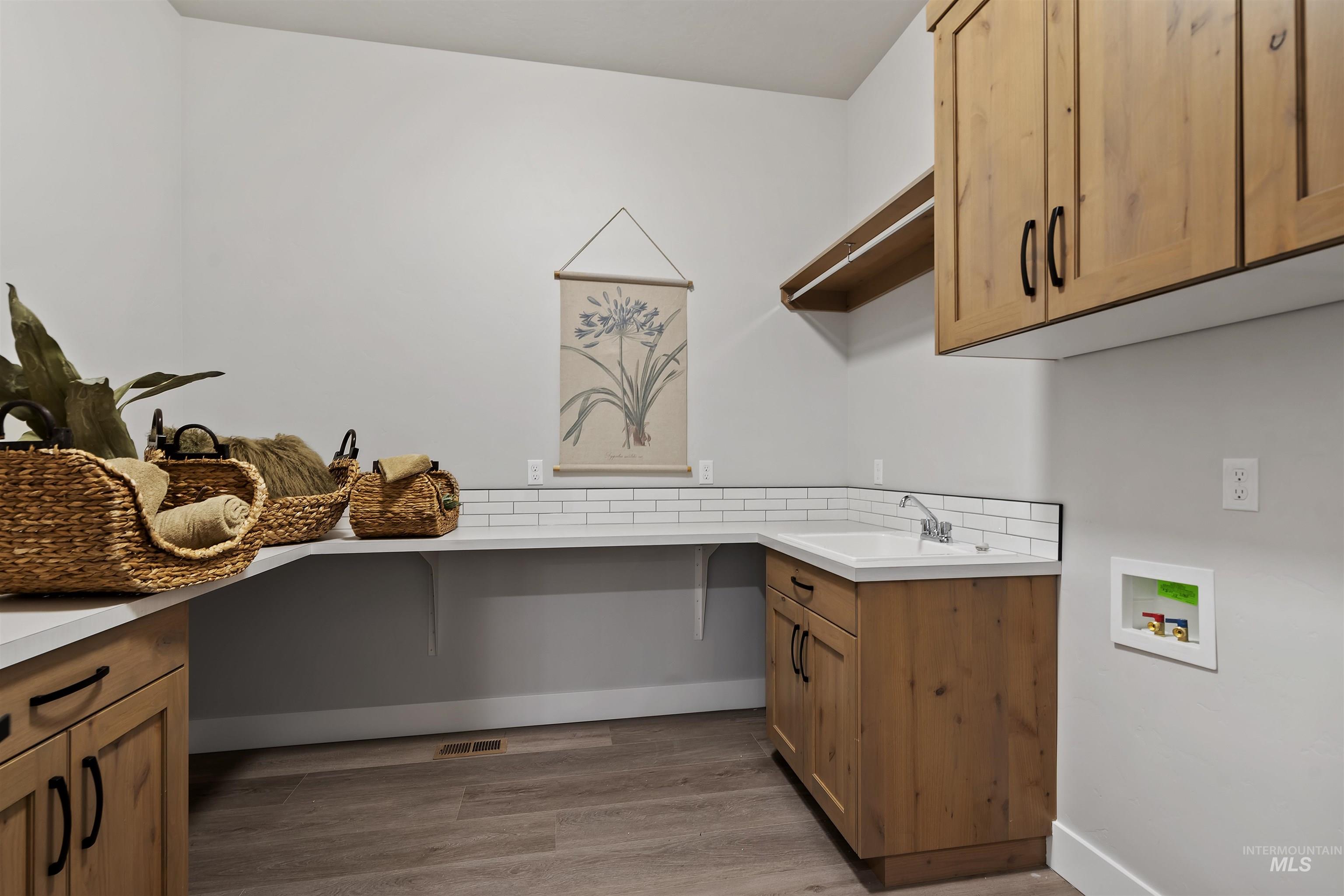 9283 Basin Kid Court Middleton, ID 83644 - Photo 13 of 21 Laundry room featuring cabinet space, light wood-style flooring, and hookup for a washing machine