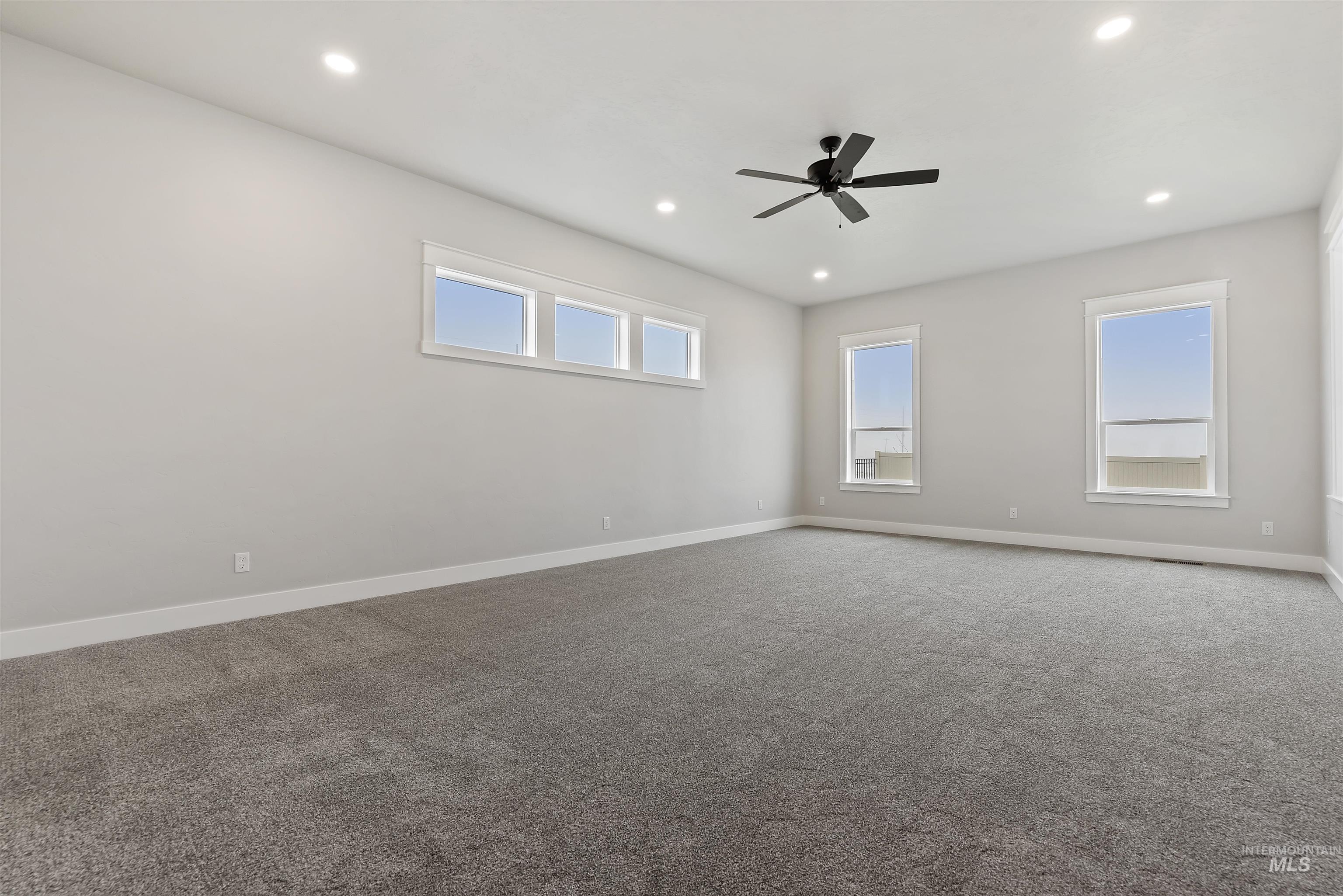 9283 Basin Kid Court Middleton, ID 83644 - Photo 15 of 21 Empty room featuring carpet floors, ceiling fan, and recessed lighting