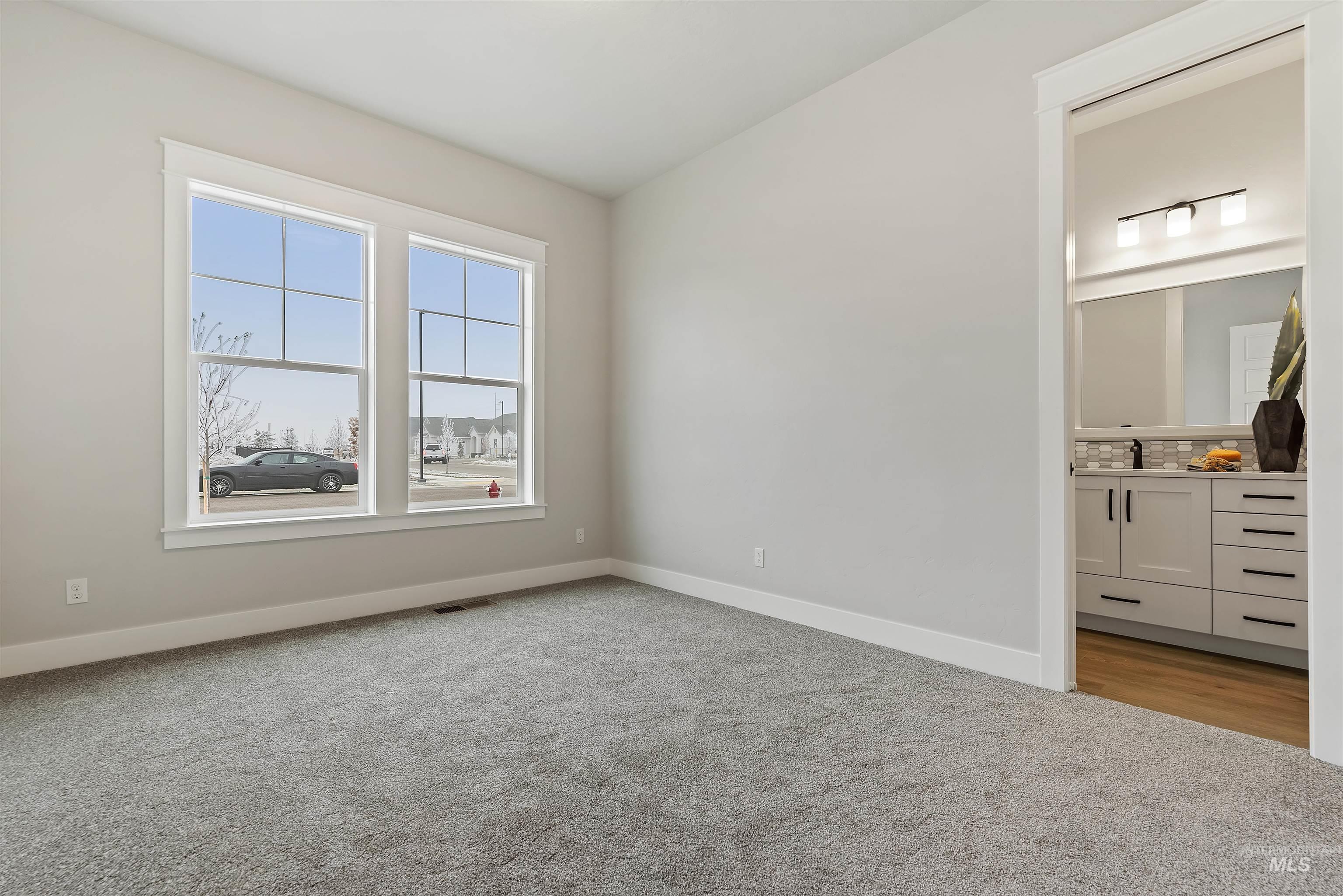 9283 Basin Kid Court Middleton, ID 83644 - Photo 16 of 21 Unfurnished bedroom featuring carpet floors and ensuite bathroom