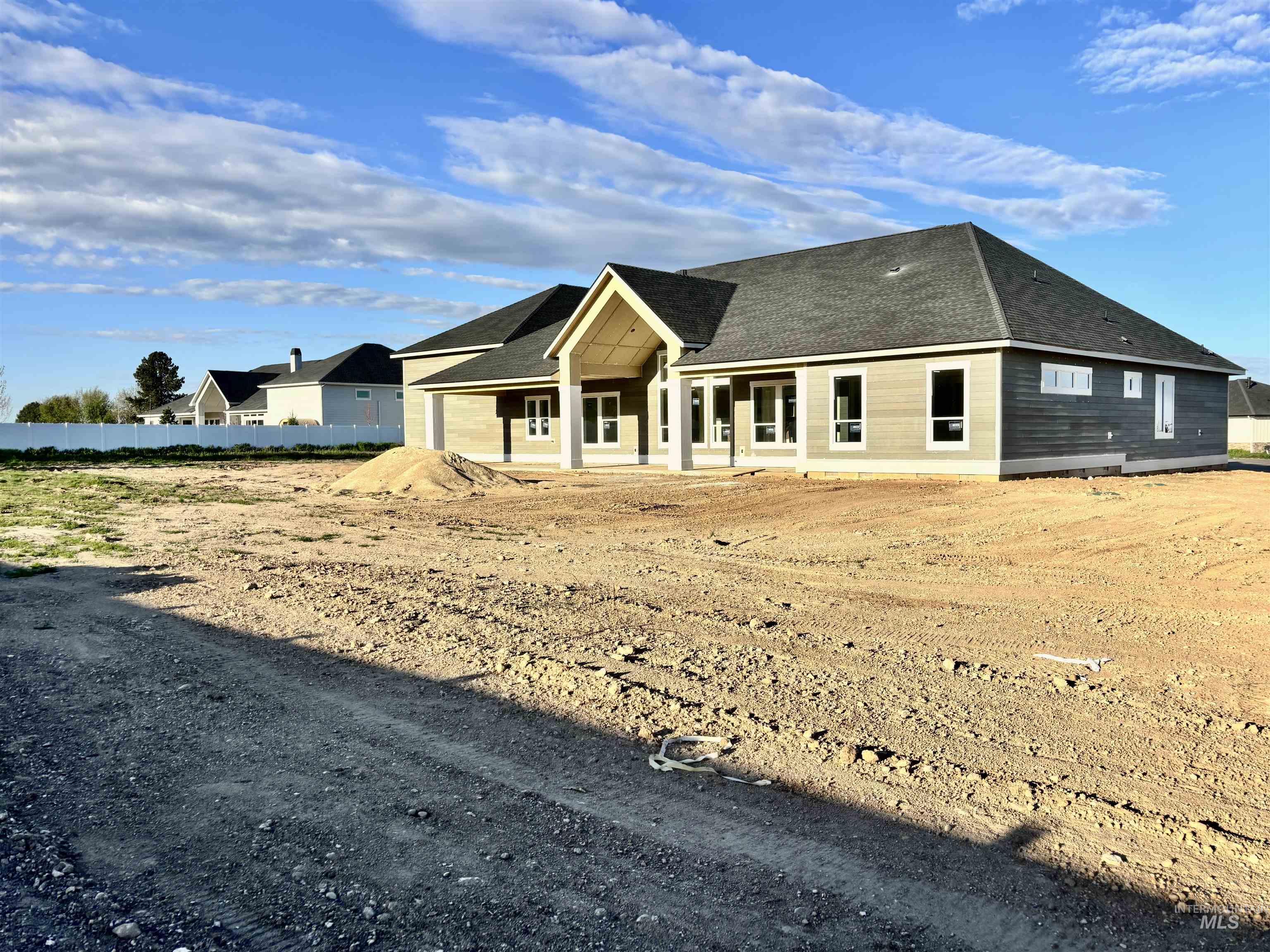 9283 Basin Kid Court Middleton, ID 83644 - Photo 18 of 21 View of front of property with a patio, an attached garage, and roof with shingles