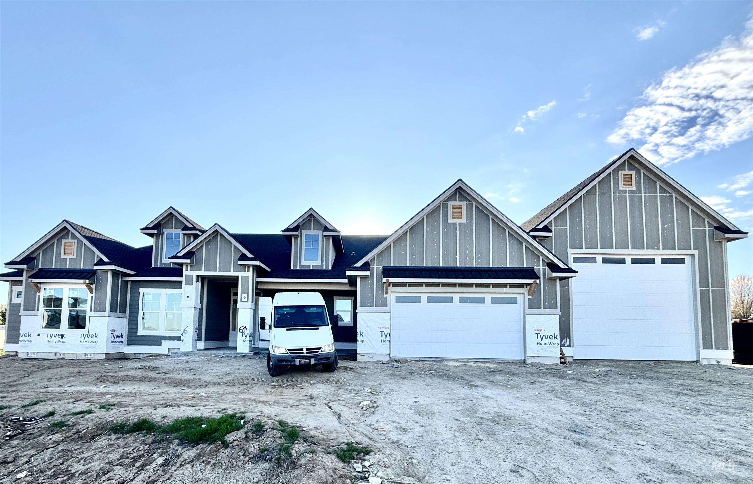 9283 Basin Kid Court Middleton, ID 83644 - Photo 2 of 21 View of front facade featuring dirt driveway, board and batten siding, and a garage