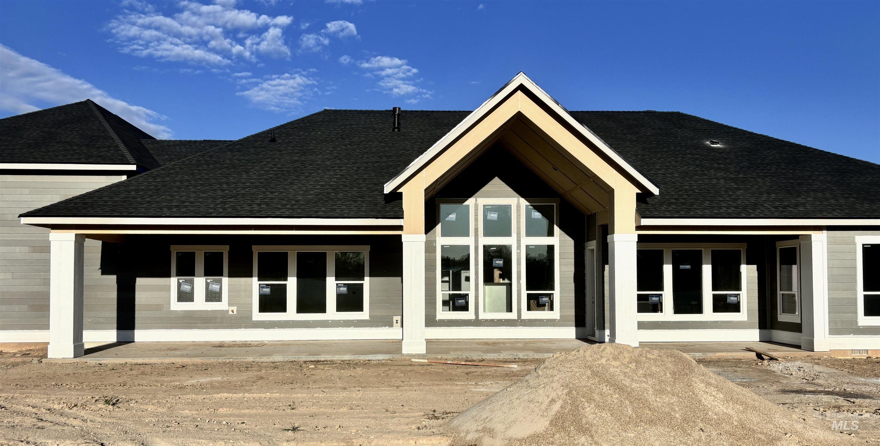 9283 Basin Kid Court Middleton, ID 83644 - Photo 19 of 21 Back of house featuring a shingled roof and a porch