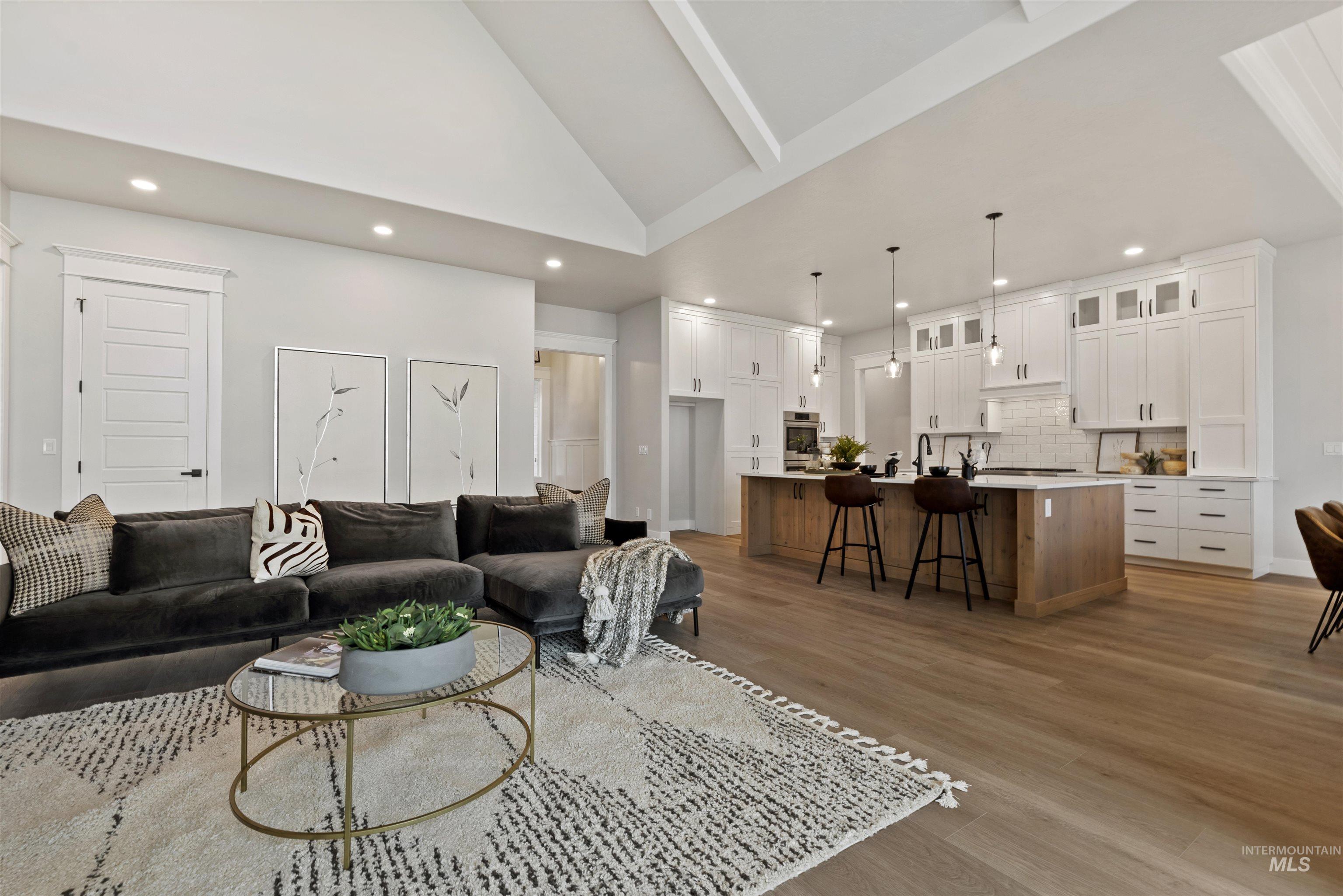 9283 Basin Kid Court Middleton, ID 83644 - Photo 3 of 21 Living room with light wood-style floors, vaulted ceiling, and recessed lighting