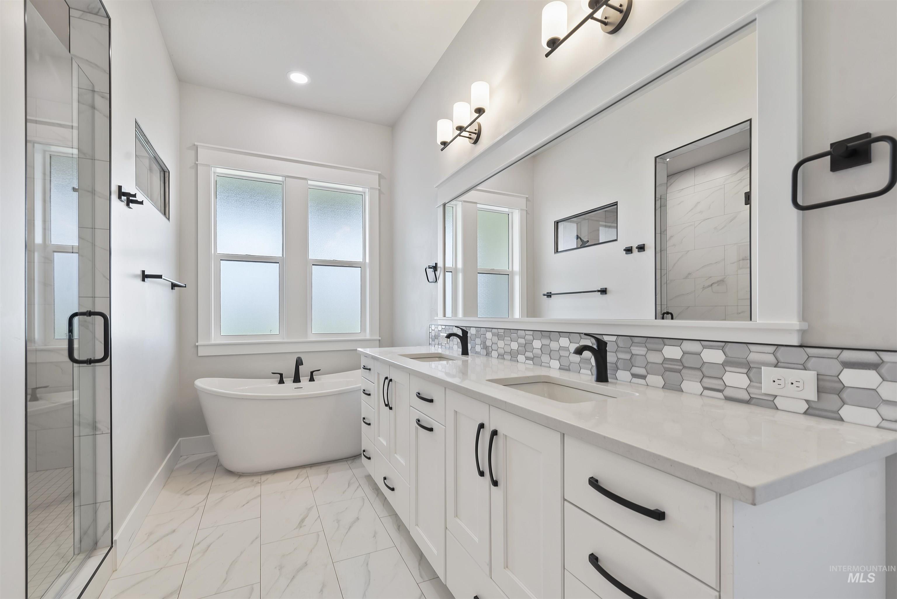 9283 Basin Kid Court Middleton, ID 83644 - Photo 7 of 21 Bathroom with a marble finish shower, double vanity, light marble finish floors, and a freestanding bath