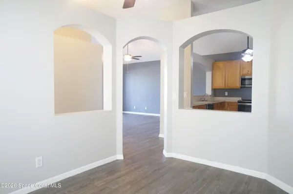 a kitchen with stainless steel appliances granite countertop a refrigerator a stove a sink and a window