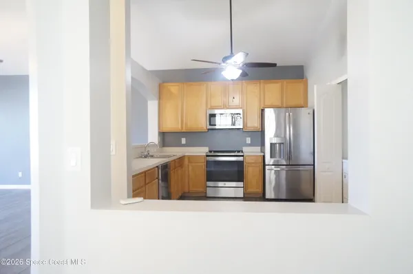 a kitchen with a refrigerator a stove a microwave a sink and cabinets