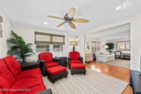 a living room with furniture and a view of kitchen