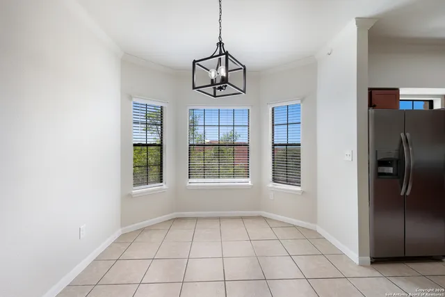 a kitchen with stainless steel appliances granite countertop a refrigerator a sink a stove a microwave and wooden cabinets