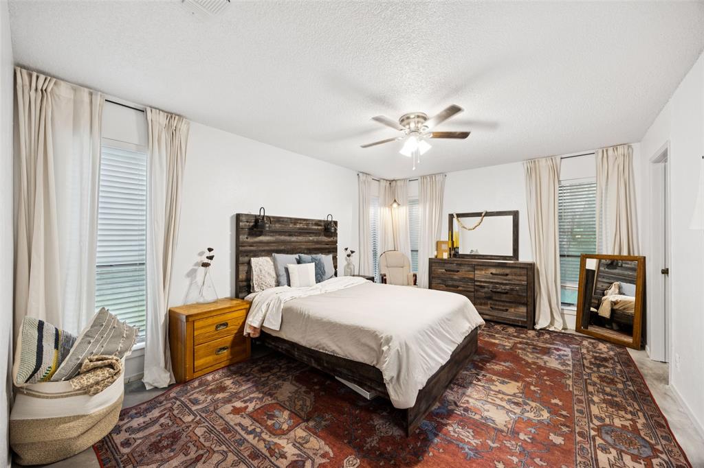 3569 Luella Road Sherman, TX 75090 - Photo 13 of 38 a bedroom with a bed and dresser with chair