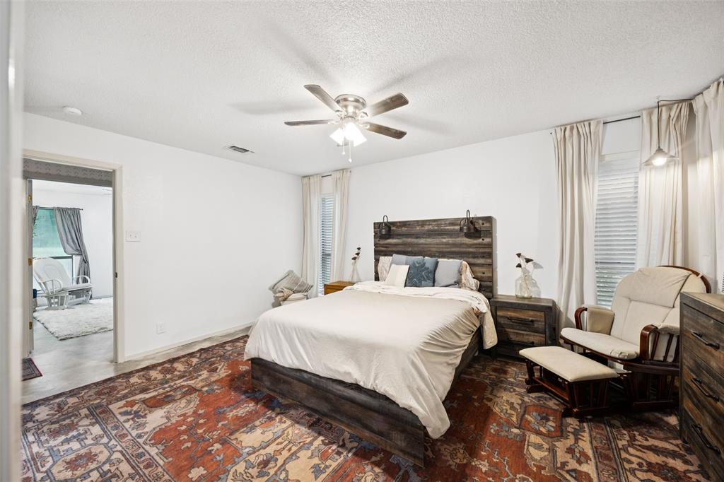 3569 Luella Road Sherman, TX 75090 - Photo 14 of 38 a bedroom with a bed and a chandelier