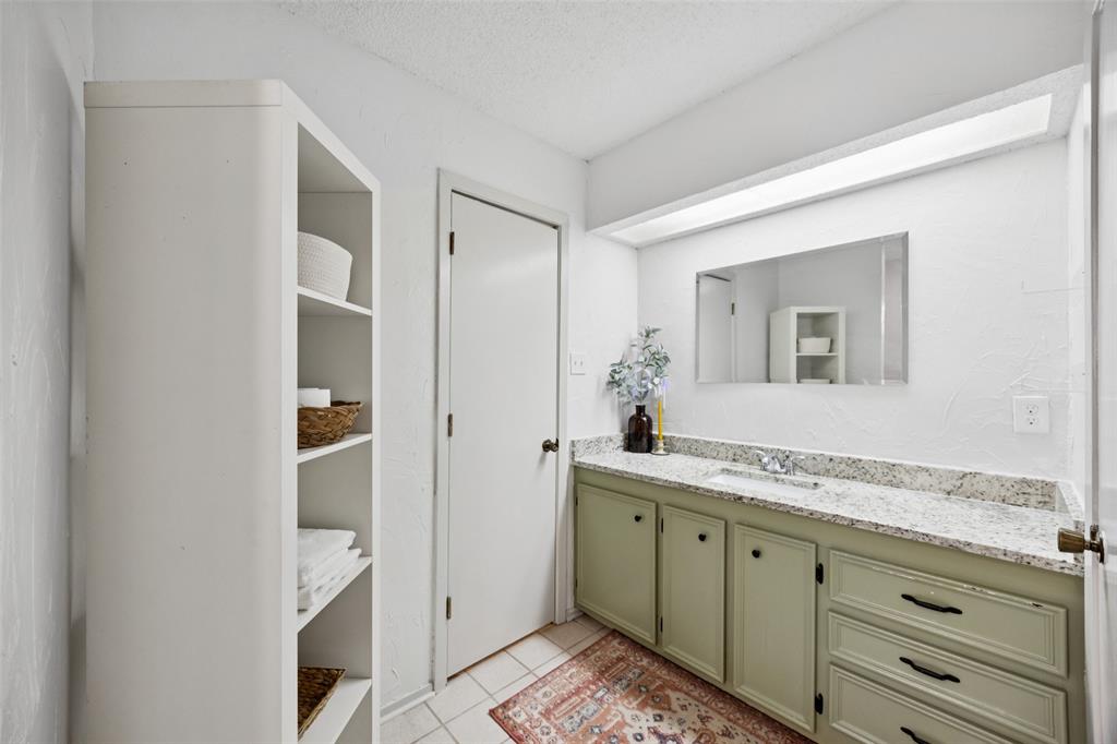 3569 Luella Road Sherman, TX 75090 - Photo 16 of 38 a spacious bathroom with a granite countertop sink and a mirror