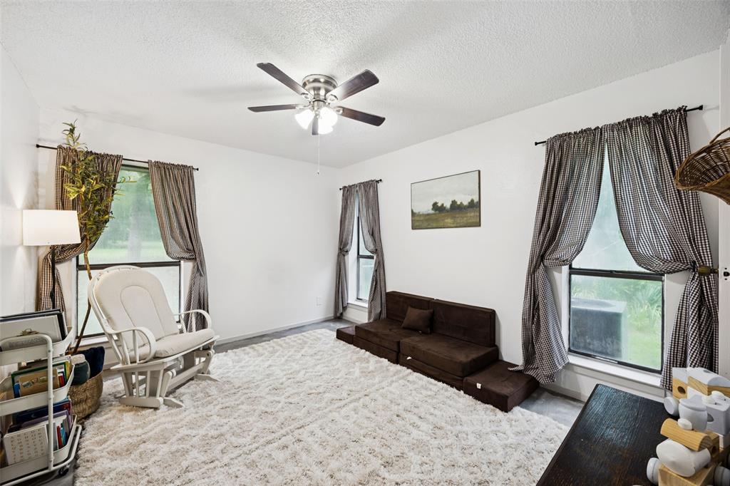 3569 Luella Road Sherman, TX 75090 - Photo 20 of 38 a living room with furniture a flat screen tv and a window