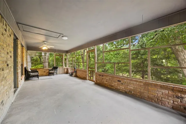 a view of a livingroom with furniture and floor to ceiling window