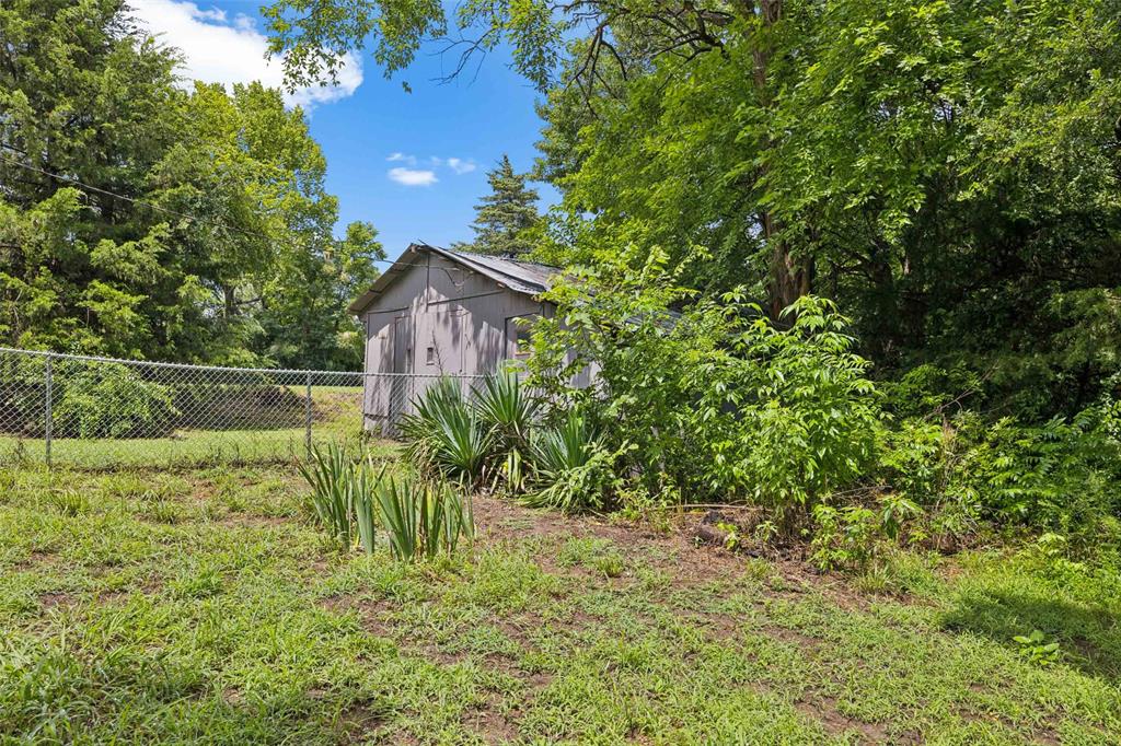 3569 Luella Road Sherman, TX 75090 - Photo 27 of 38 a view of a yard with plants and large trees