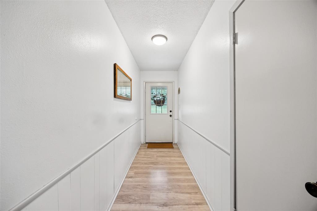 3569 Luella Road Sherman, TX 75090 - Photo 3 of 38 a view of a hallway with wooden floor and staircase