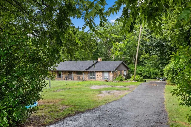 a house with swimming pool in front of it