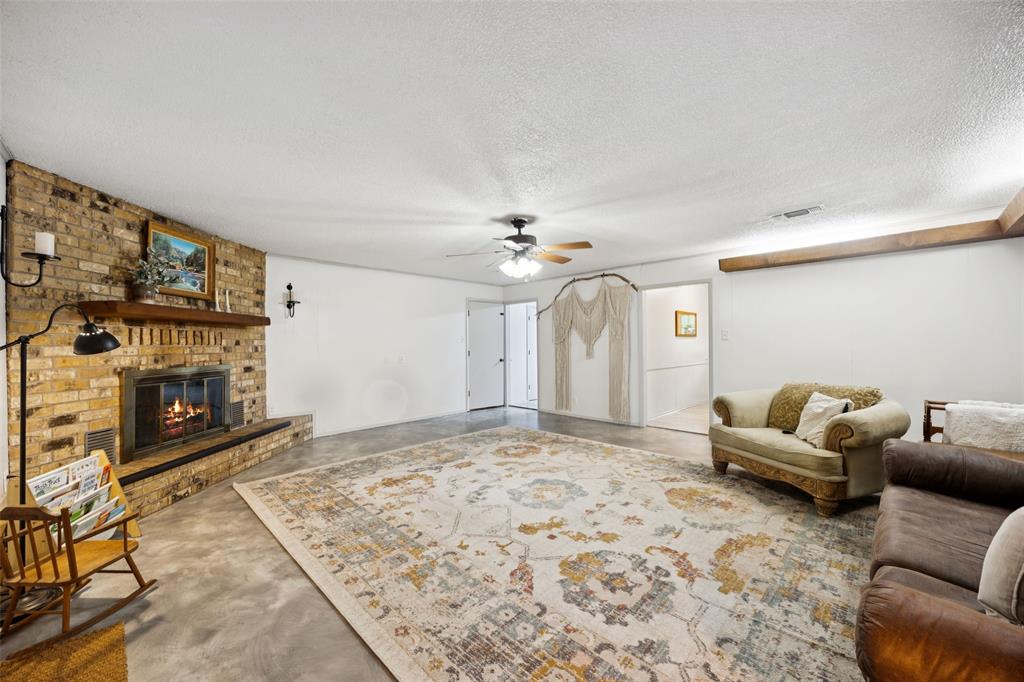 3569 Luella Road Sherman, TX 75090 - Photo 5 of 38 a living room with furniture and a fireplace