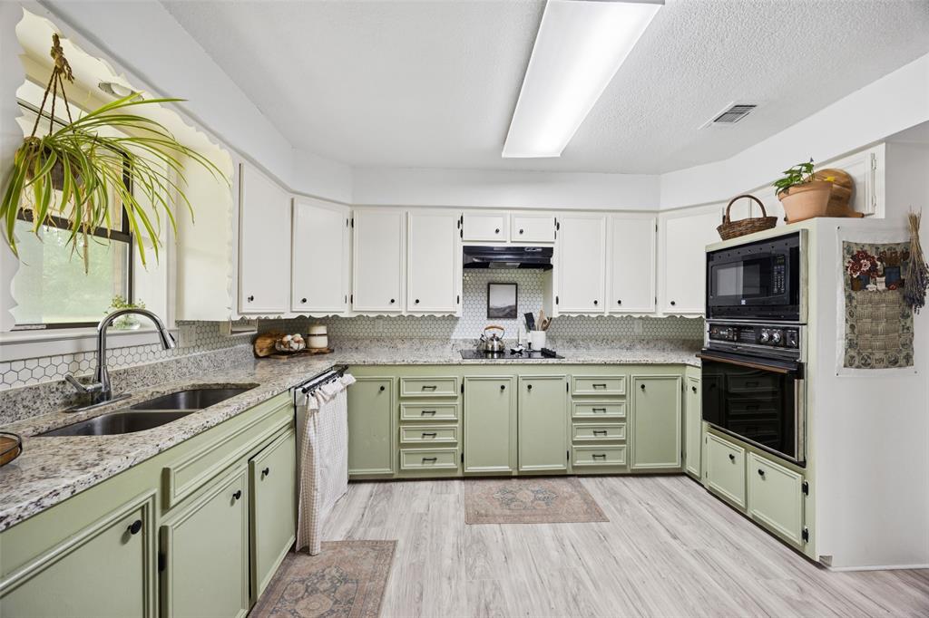 3569 Luella Road Sherman, TX 75090 - Photo 7 of 38 a kitchen with a sink cabinets and appliances