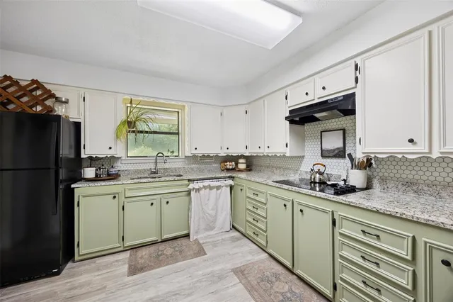 a kitchen with a sink stainless steel appliances and cabinets