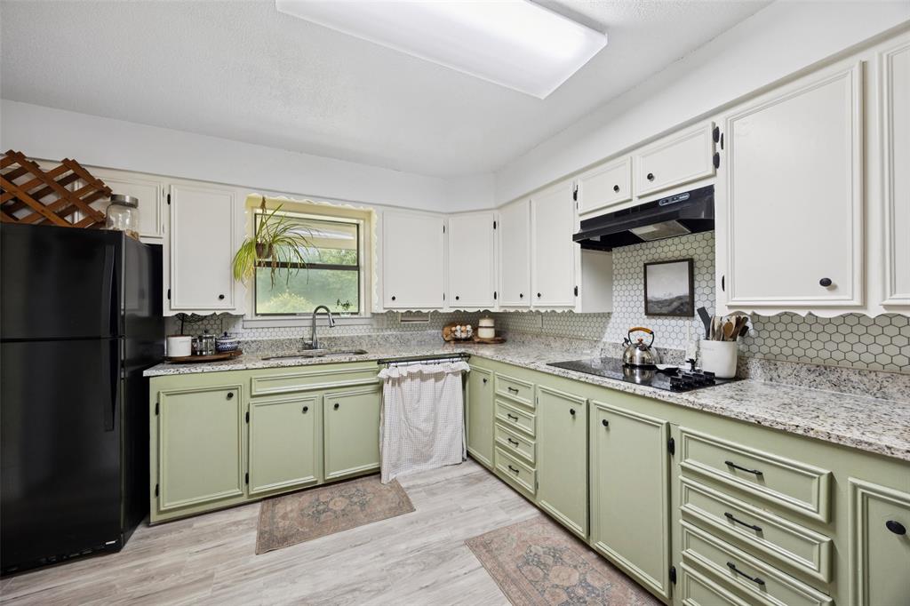 3569 Luella Road Sherman, TX 75090 - Photo 8 of 38 a kitchen with a sink stainless steel appliances and cabinets