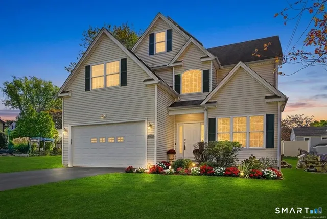 a front view of a house with a yard and trees