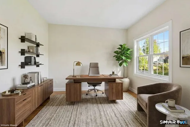 a living room with furniture a rug and a window