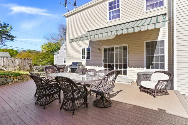 a view of a patio with a dining table and chairs with wooden floor