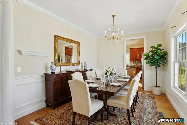 a view of a dining room with furniture and window