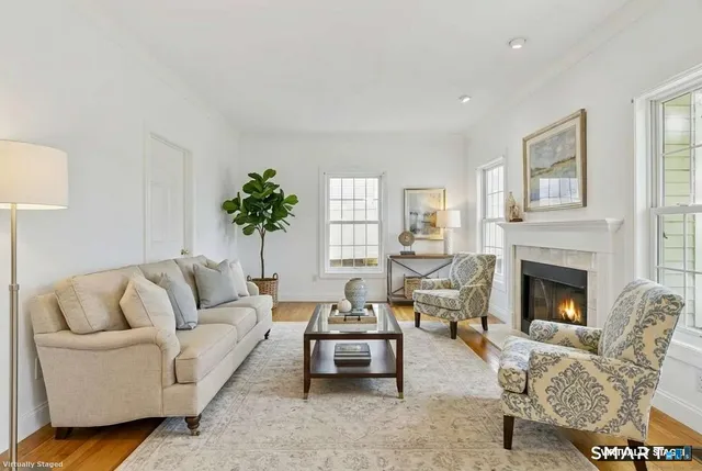 a living room with furniture and a fireplace