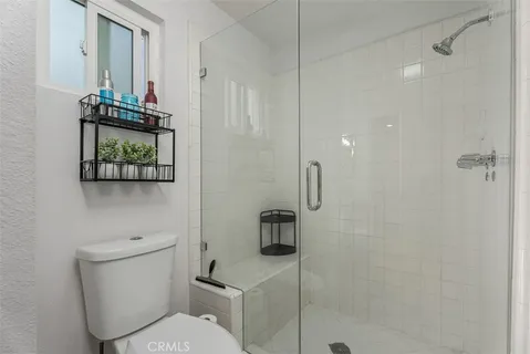 a bathroom with a toilet a sink and shower