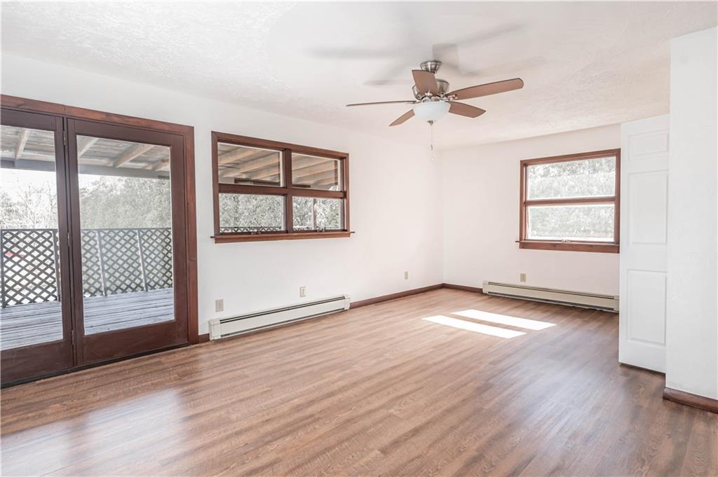 12 Bush Road Home, PA 15747 - Photo 10 of 22 an empty room with wooden floor fan and windows