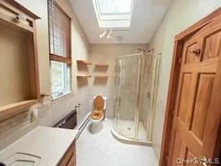 a bathroom with a tub shower and a sink