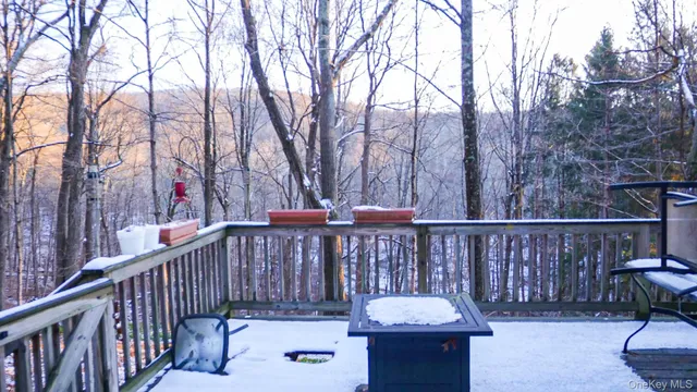 a living room with furniture a flat screen tv and next to a window