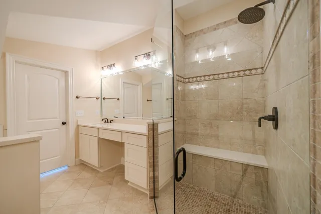 a bathroom with a shower sink and mirror