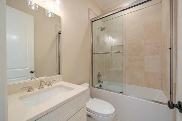 a bathroom with a bathtub shower sink vanity and toilet