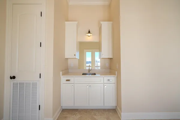 a bathroom with a sink a light fixture and a mirror