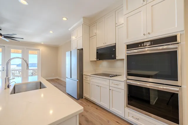 a kitchen with stainless steel appliances a stove microwave and cabinets