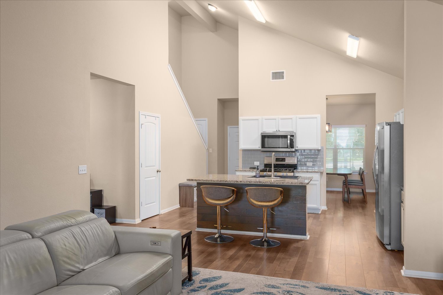 717 Kaluga Trail Leander, TX 78641 - Photo 5 of 40 a living room with furniture a flat screen tv and wooden floor