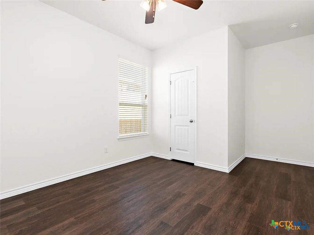5104 Rose Gdn Loop Killeen, TX 76542 - Photo 13 of 29 an empty room with wooden floor cabinet and windows