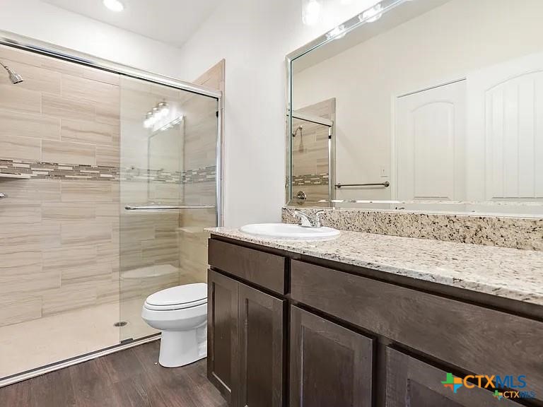 5104 Rose Gdn Loop Killeen, TX 76542 - Photo 18 of 29 a bathroom with a granite countertop sink toilet and shower