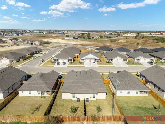 an aerial view of residential houses with outdoor space