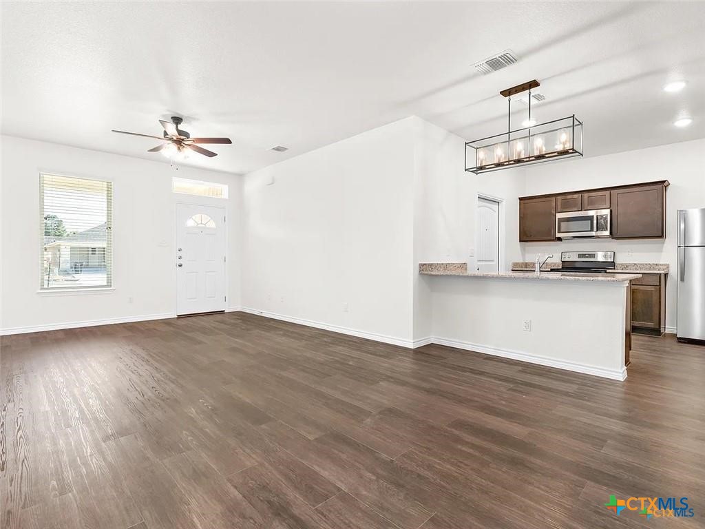 5104 Rose Gdn Loop Killeen, TX 76542 - Photo 6 of 29 a view of kitchen with sink microwave and wooden floor