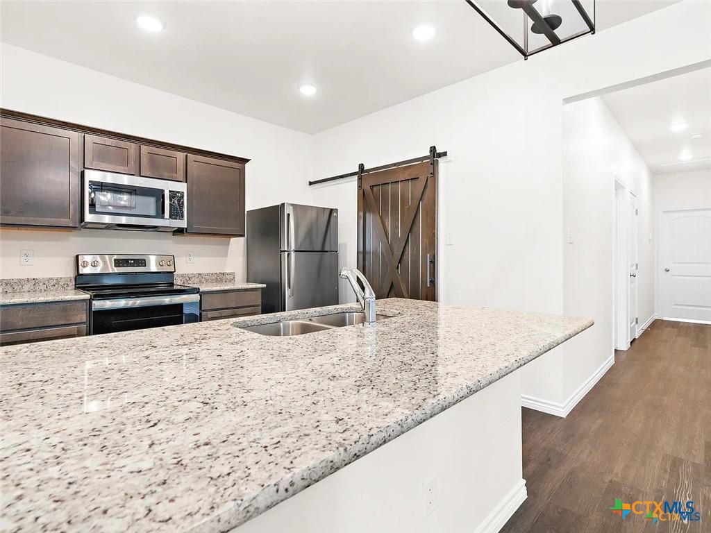 5104 Rose Gdn Loop Killeen, TX 76542 - Photo 7 of 29 a kitchen with stainless steel appliances granite countertop a refrigerator and a sink