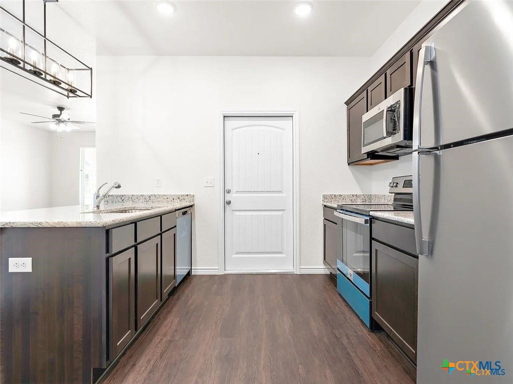 5104 Rose Gdn Loop Killeen, TX 76542 - Photo 9 of 29 a kitchen with a refrigerator stove and sink