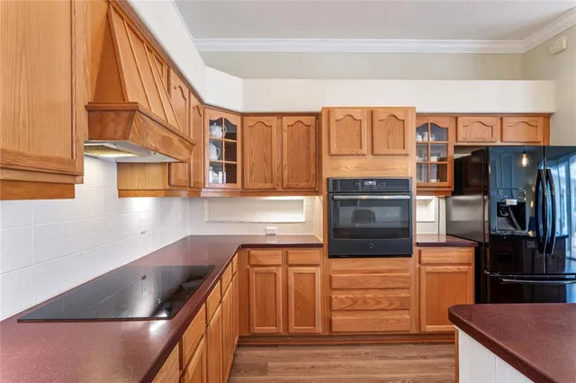 a kitchen with stainless steel appliances granite countertop a refrigerator and a stove