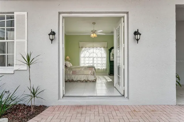 a view of a living room and a balcony with furniture