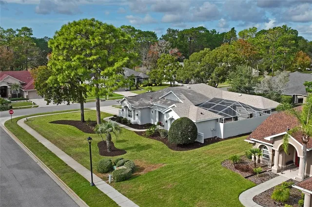 an aerial view of a house with swimming pool and garden