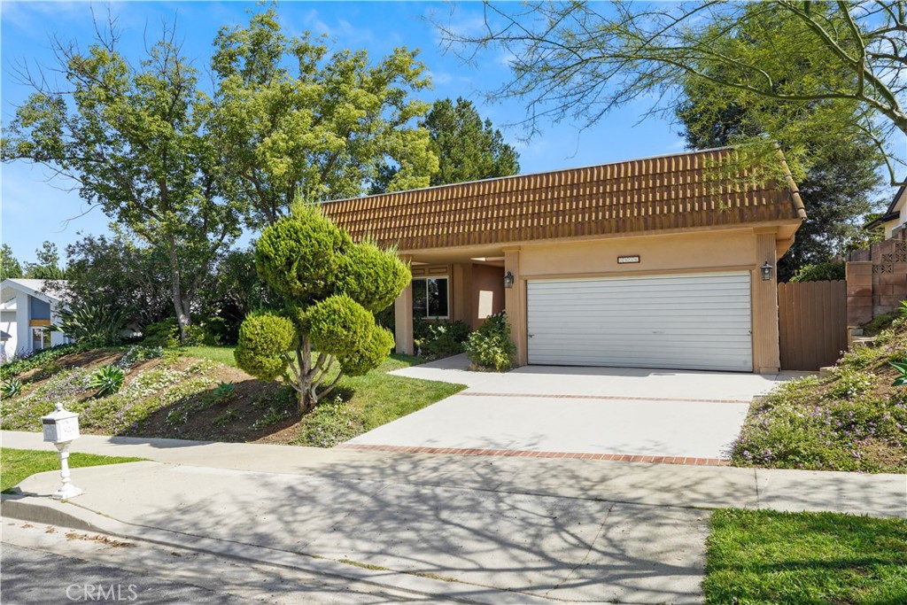 3136 Voltaire Drive Topanga, CA 90290 - Photo 1 of 48 a front view of a house with a yard and garage