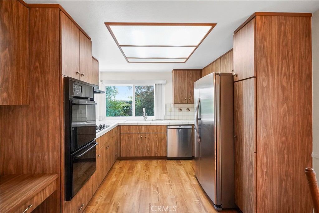 3136 Voltaire Drive Topanga, CA 90290 - Photo 12 of 48 a kitchen with stainless steel appliances granite countertop a refrigerator and a stove top oven